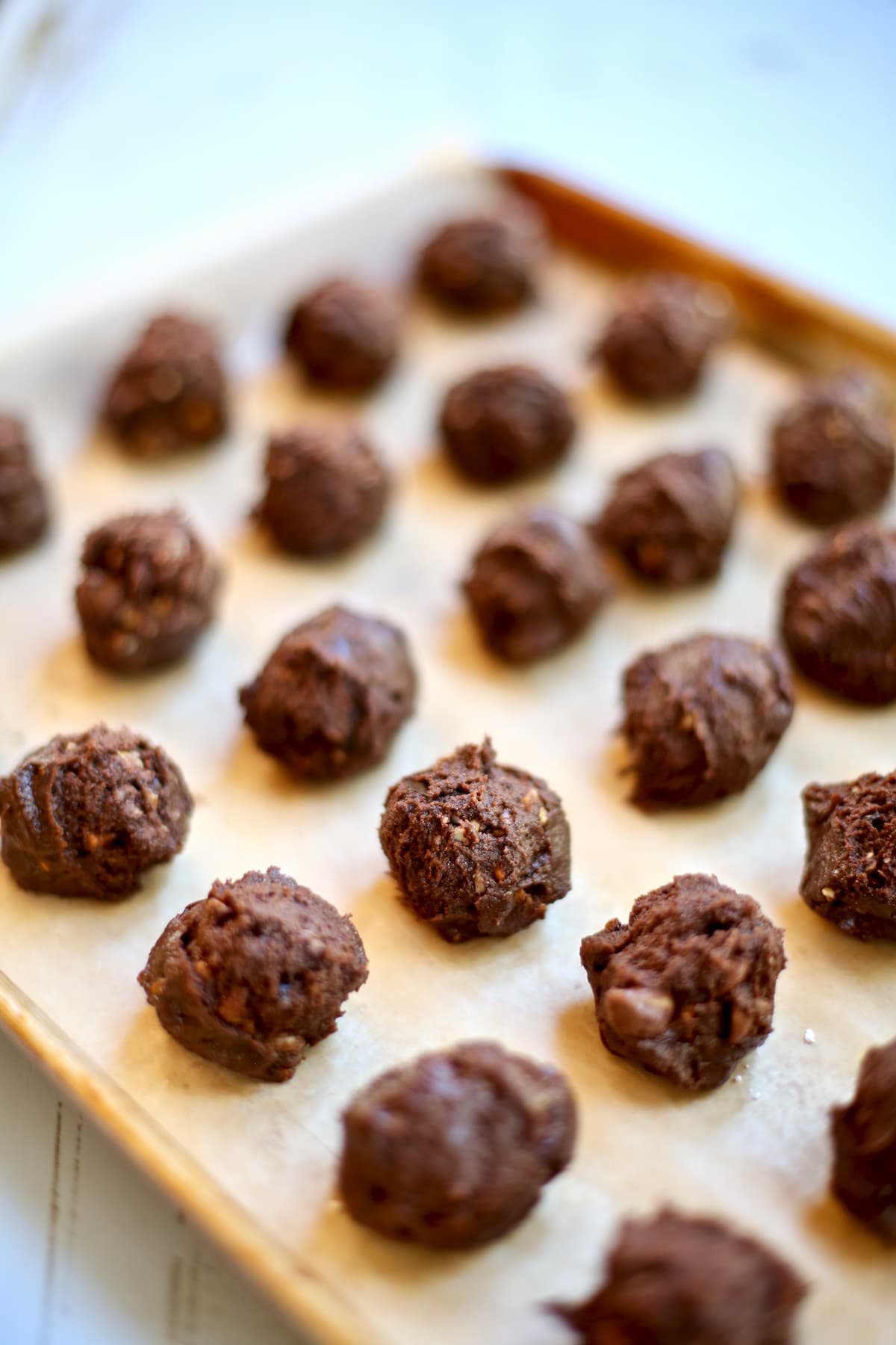 a tray of unbaked chocolate cookies