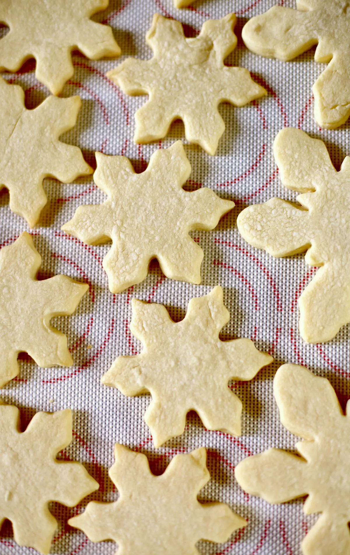 Cooled cookies and white chocolate and sprinkles on a baking sheet