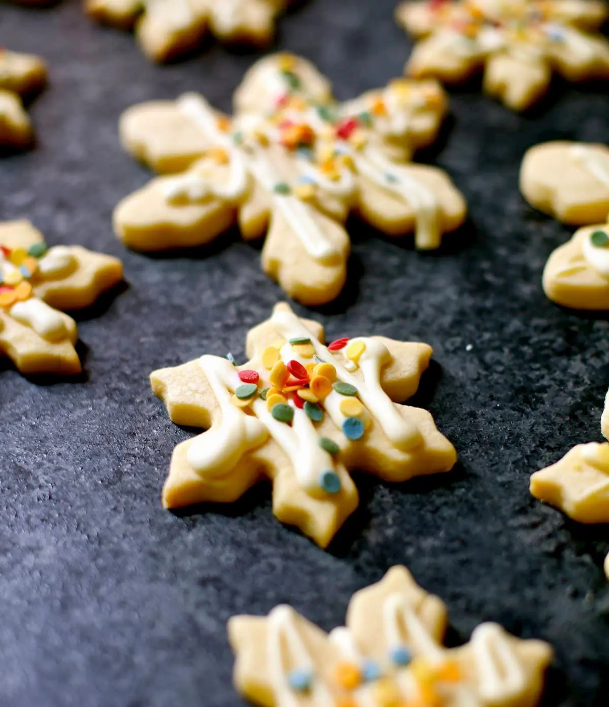 decorated sugar cookies on a black board