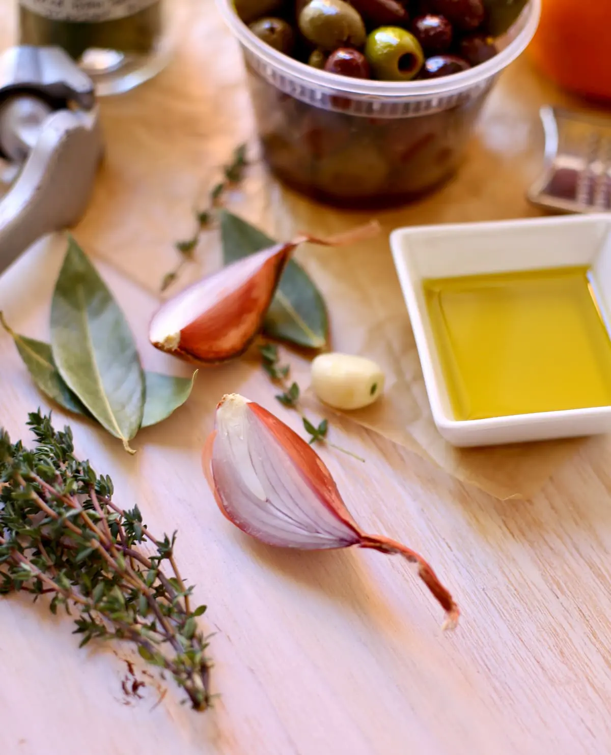 a shallot and other ingredients and herbs on a table