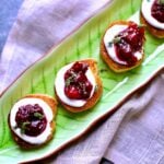 a green tray with goat cheese toasts on it.