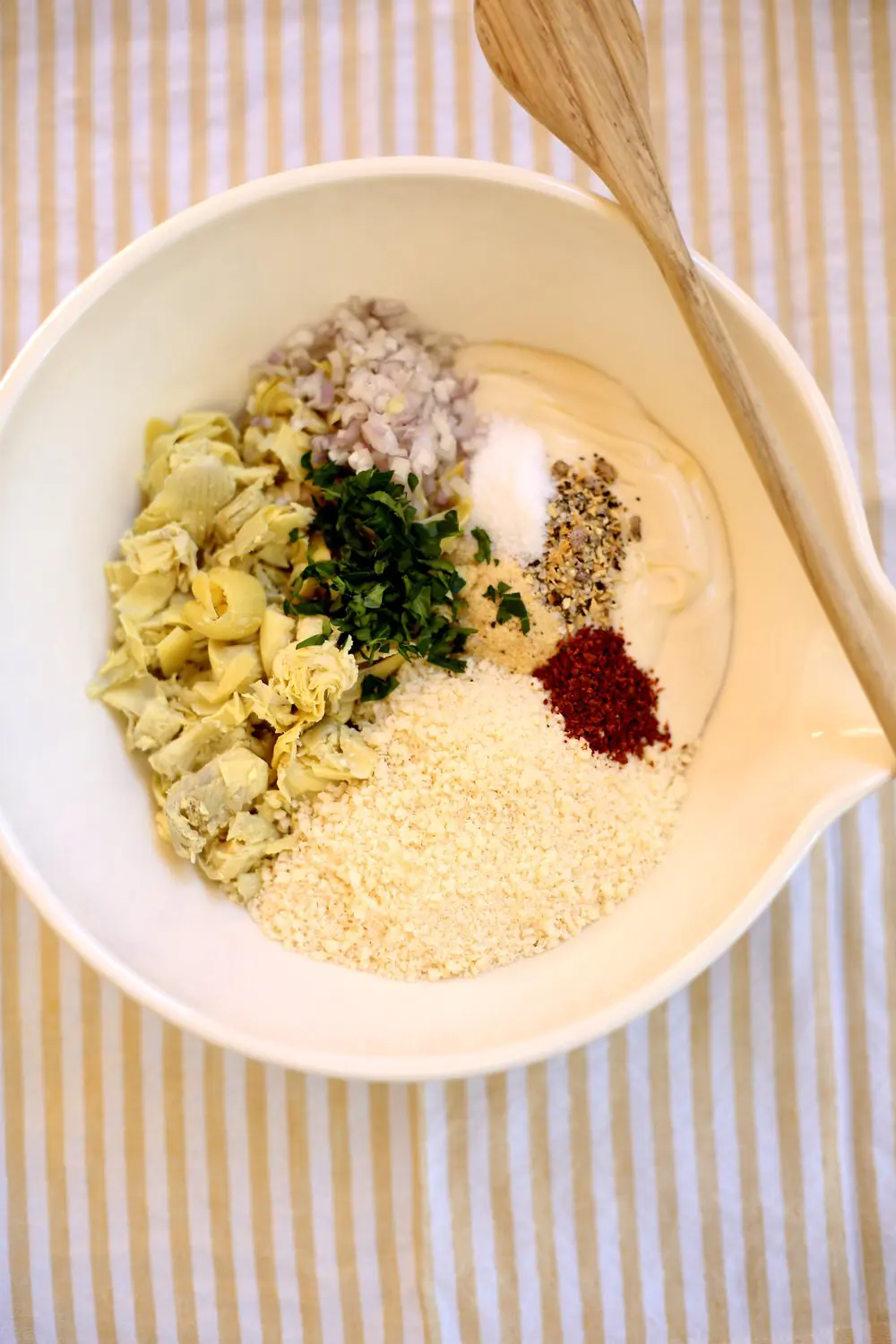 a white bowl full of ingredients for a dip