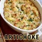 a white dish of artichoke dip on a table with a text overlay of the name of the dish