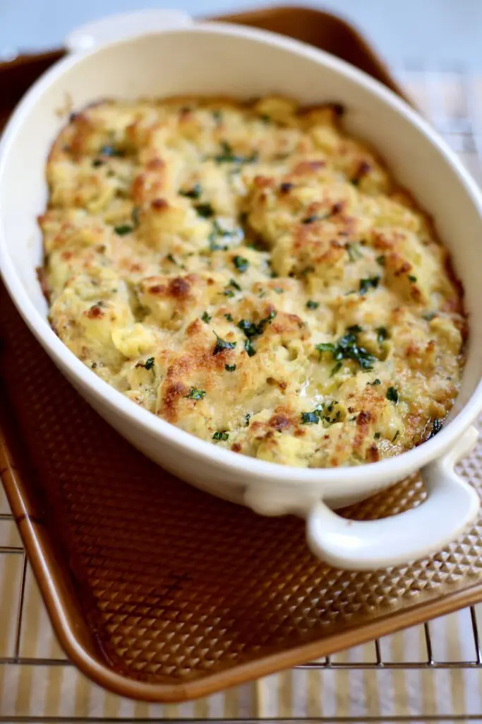 a casserole dish of hot artichoke dip