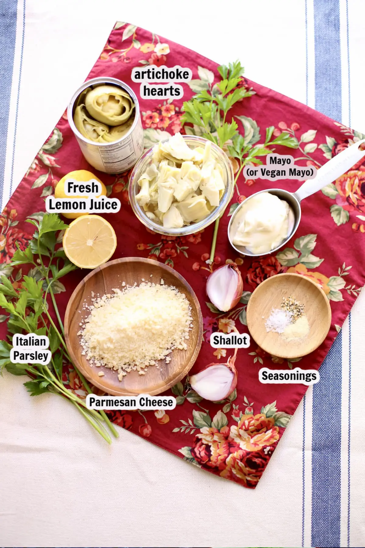 a spread of ingredients for artichoke dip with captions of each item, artichoke hearts, parmesan, etc.