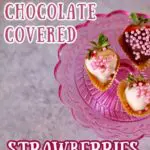 three chocolate strawberries on a pink stand