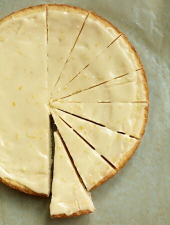 a round of lemon iced shortbread, cut in slices on a piece of parchment paper