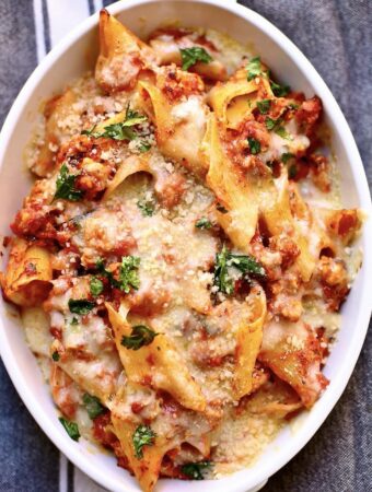 baked pasta in a white casserole dish on a gray table