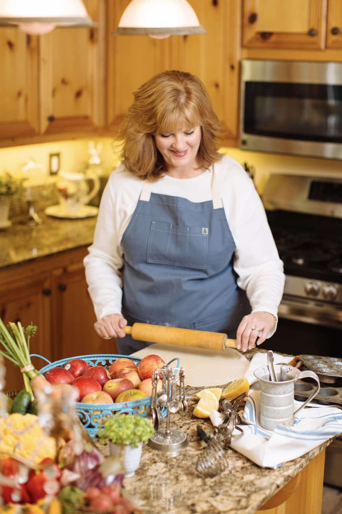 picture of studio delicious author Paige in the kitchen chopping vegetables