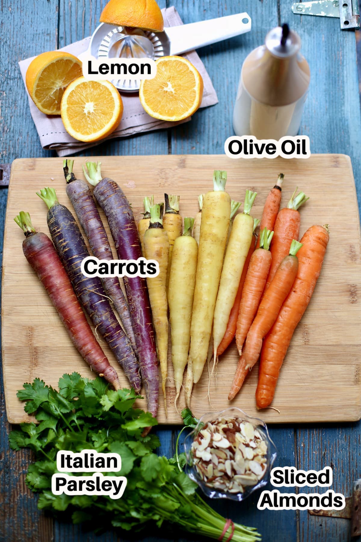 carrots and lemon and olive oil and parsley on a cutting board with blacka nd white text overlay