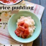 a bowl of rice pudding with rhubarb on a tablecloth in a blue bowl.