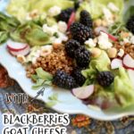 a blue plate with salad of blackberries, goat cheese and grains and radish on a tablecloth with text overlay