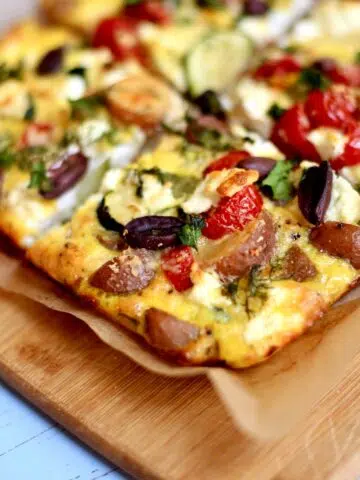 a frittata on a cutting board.