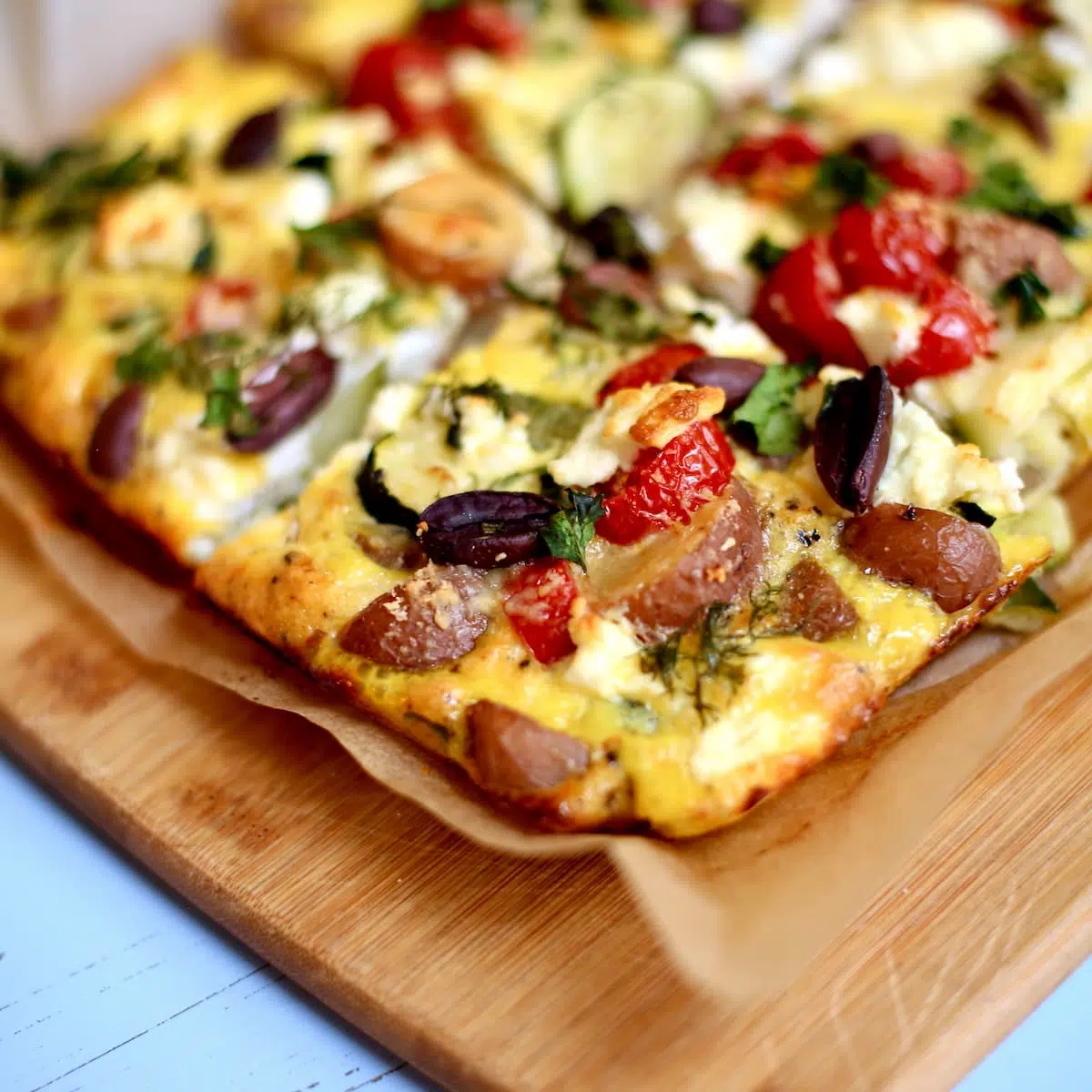 a frittata on a cutting board.