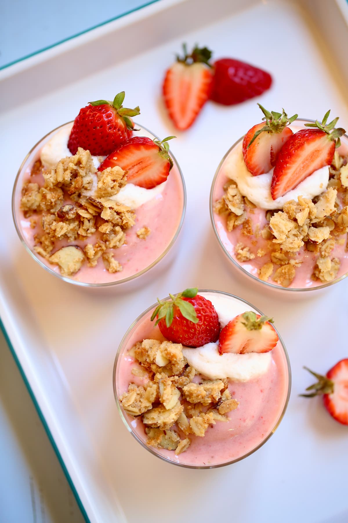 some strawberry flavored smoothies on a white tray.