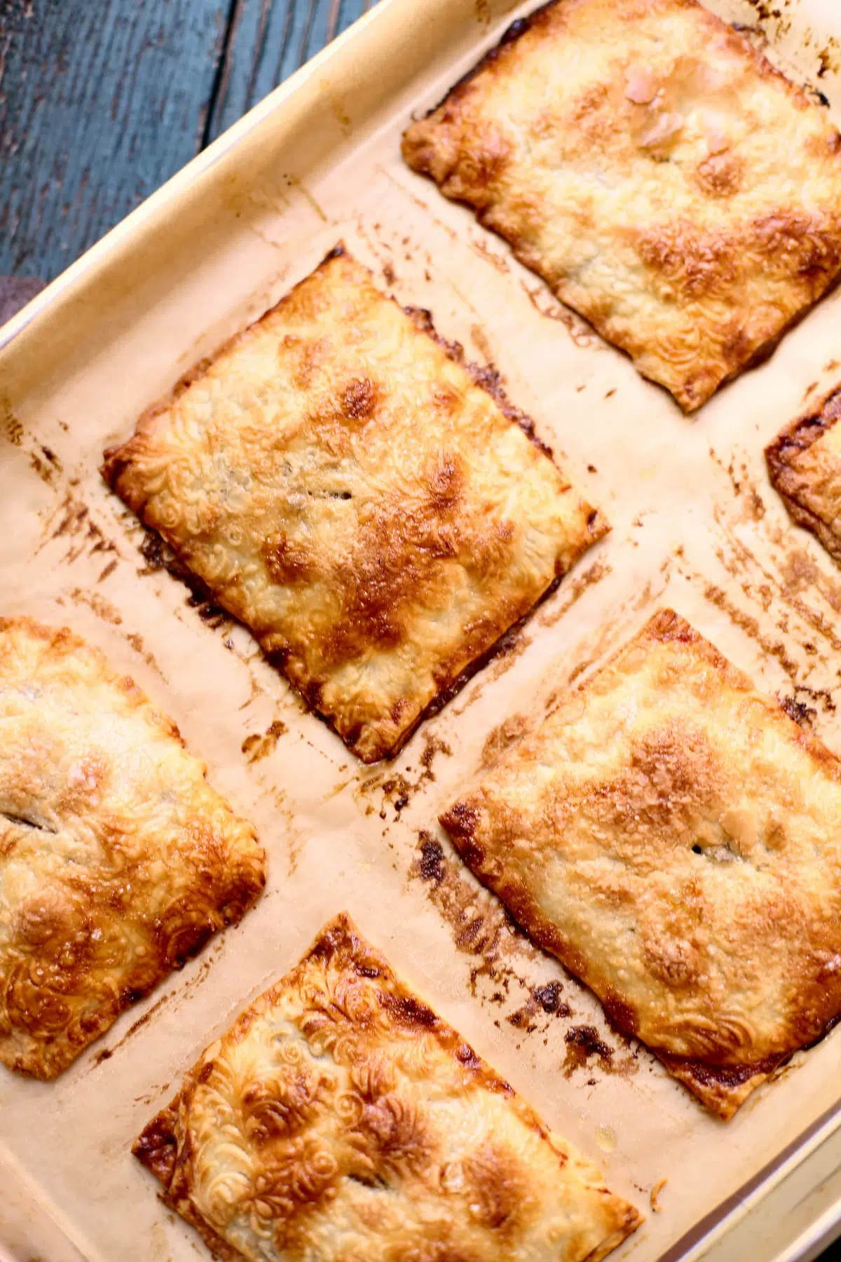 a baking sheet with baked hand pies, fresh out of the oven.