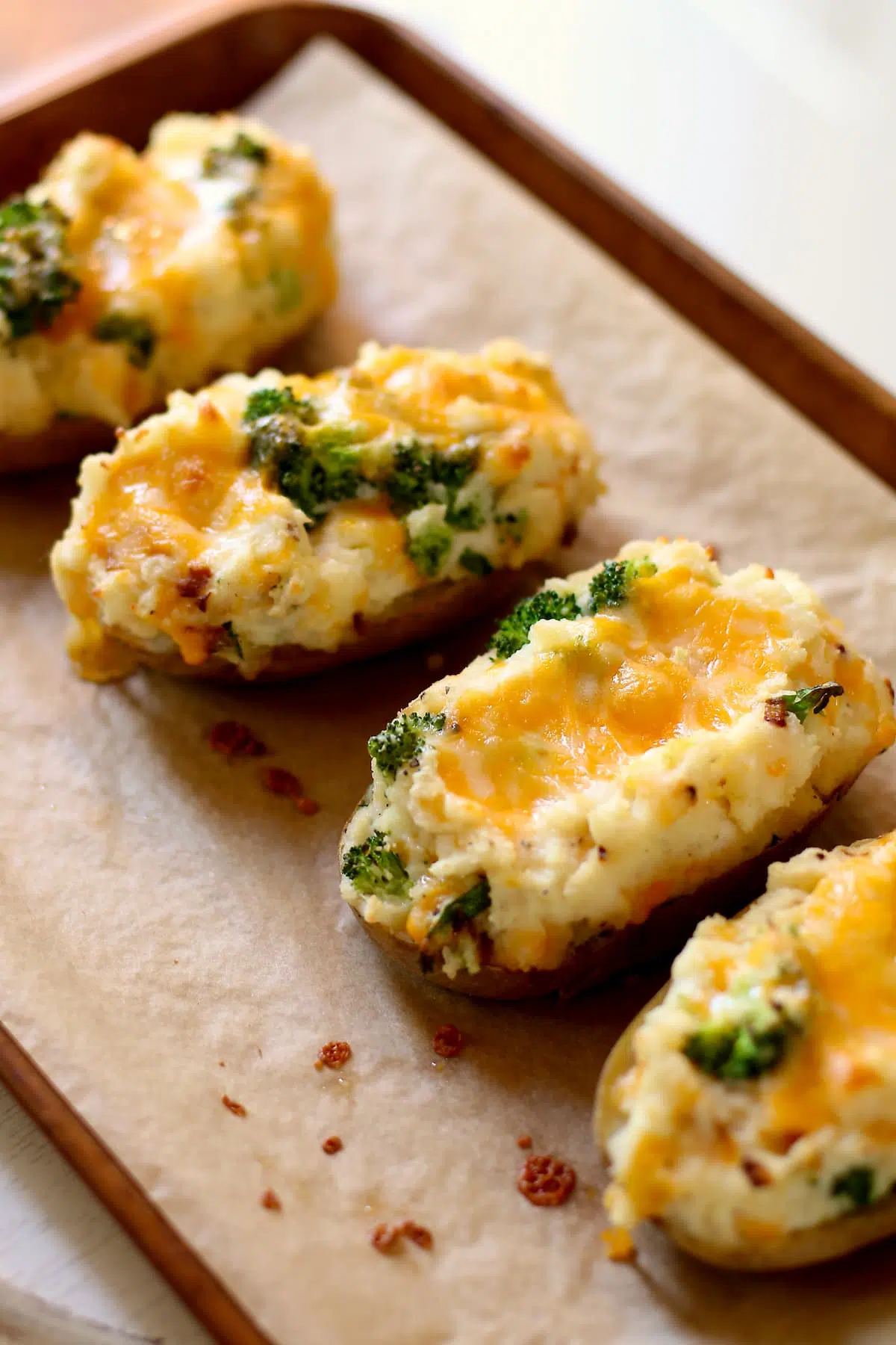 a sheet pan of potatoes with broccoli and cheese.