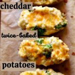 four potatoes with melted cheddar, with text on the top of the photo saying the name of the recipe.