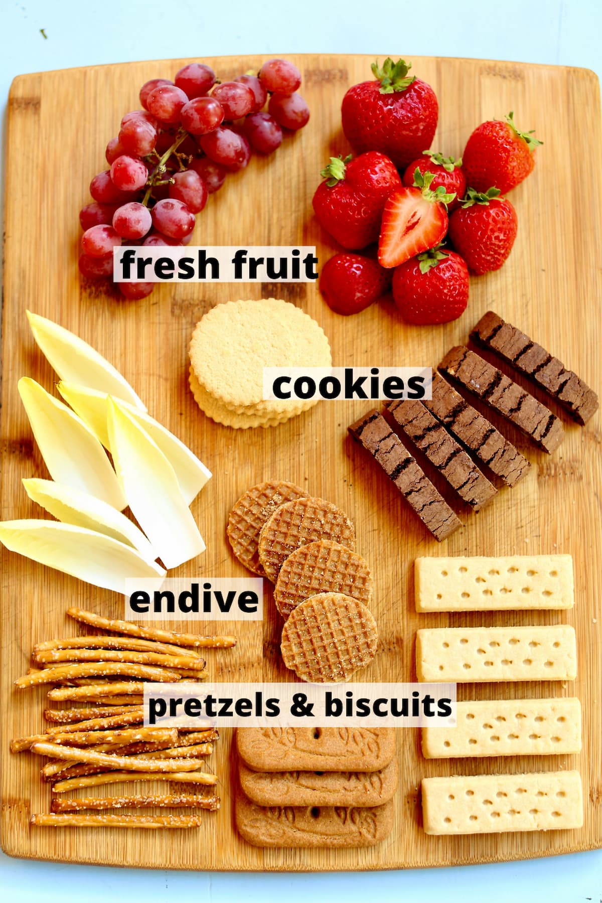 a wooden table with ingredents, fresh fruit, cookies, etc. with a text overlay saying the ingredient name.