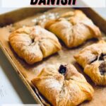 a baking sheet of four pastries sprinkled with powdered sugar with a text overlay saying the recipe name.