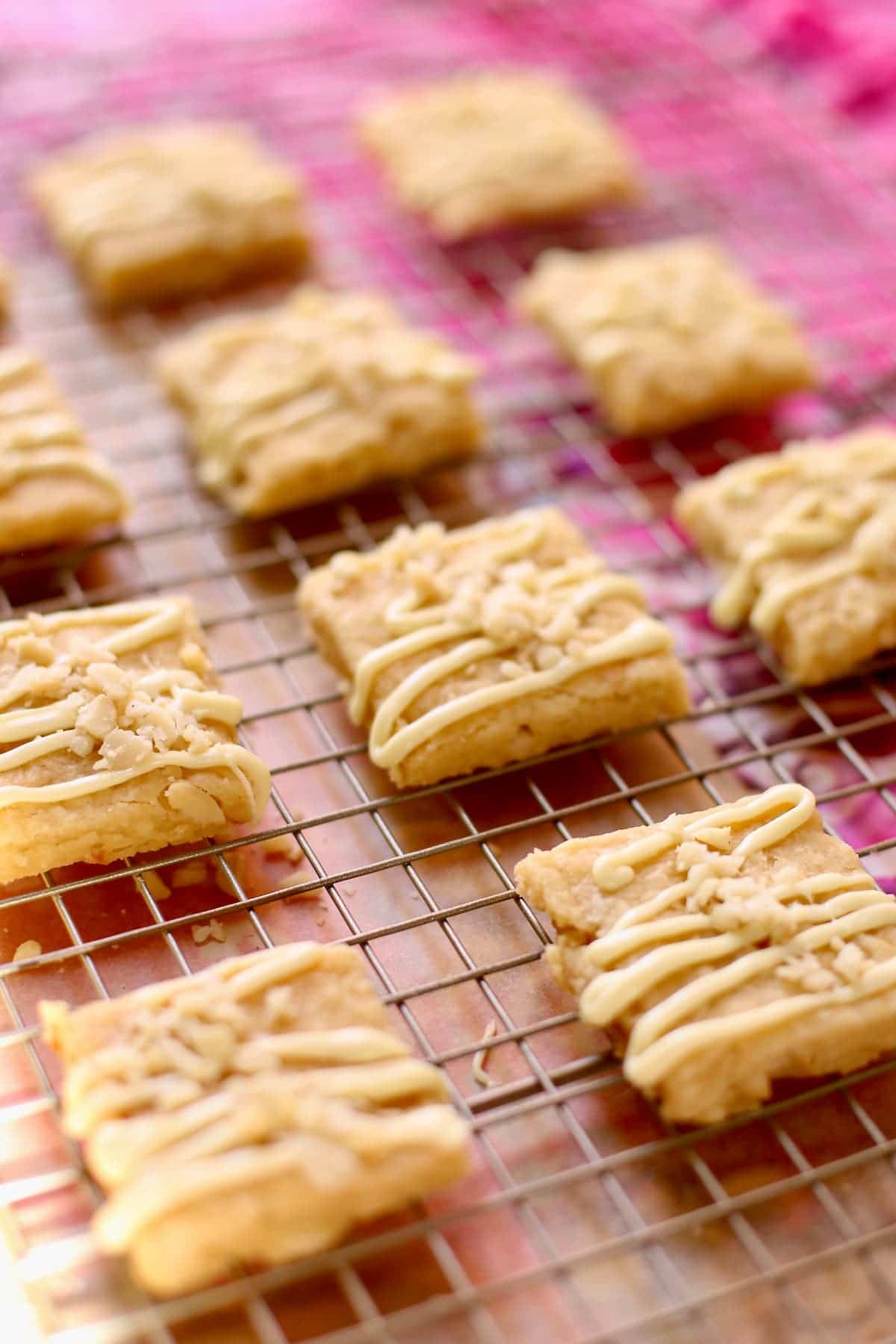a row of macadamia nut shortbread on a wire rack.
