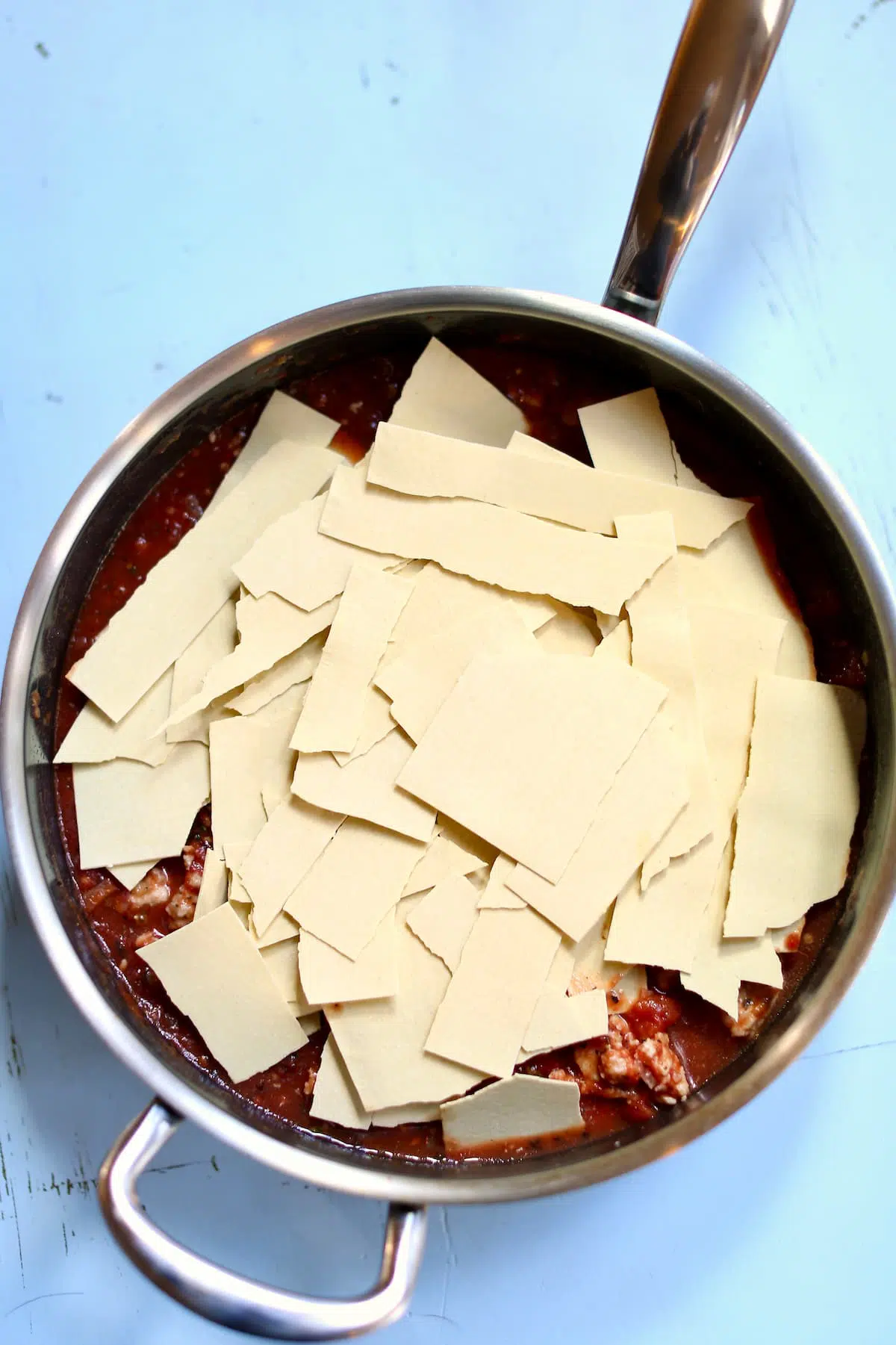 a skillet of dried pasta noodles.