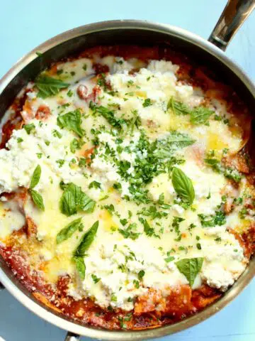 a skillet of pasta with cheese and ground turkey.