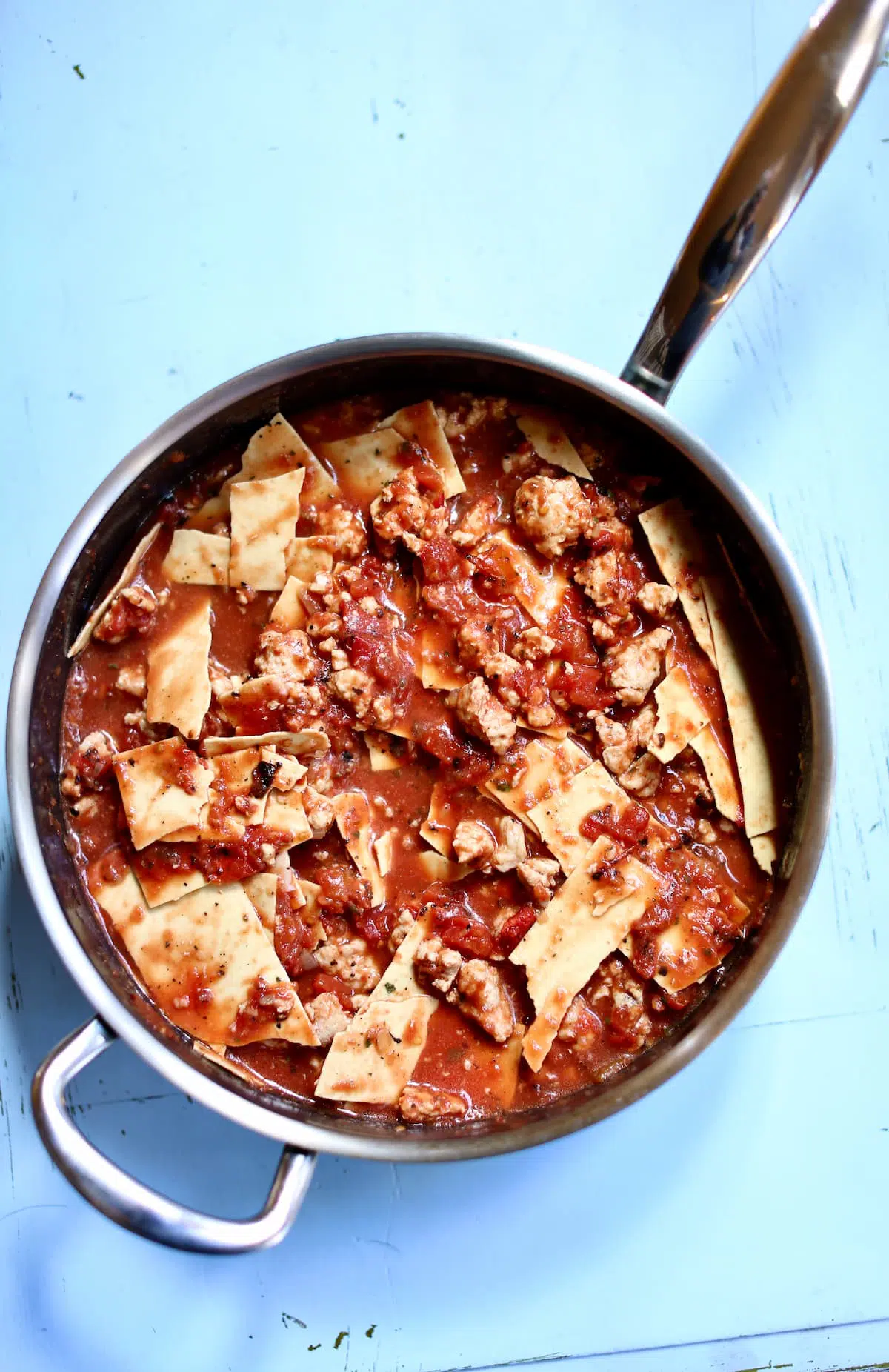 a skillet of red sauce pasta.