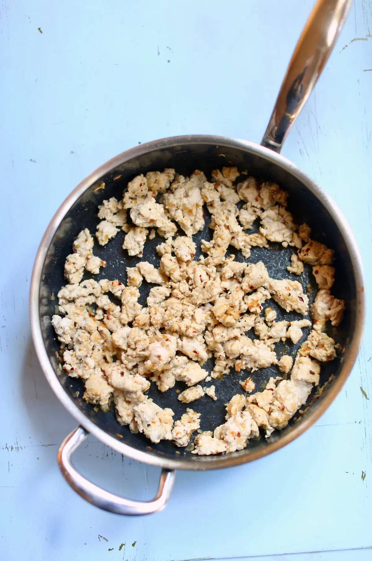 a skillet with cooked ground turkey.