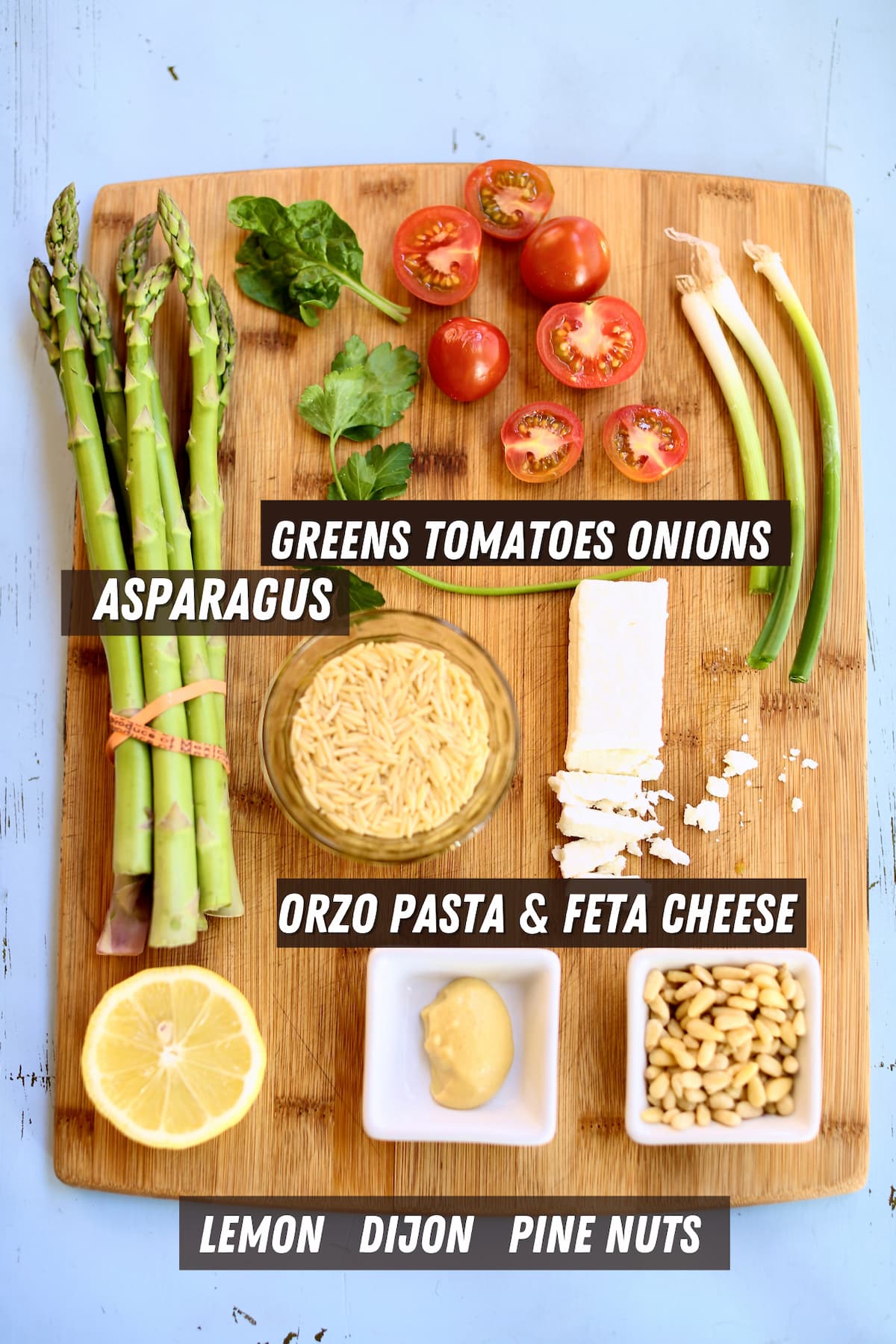 a cutting board with different ingredients for pasta salad.