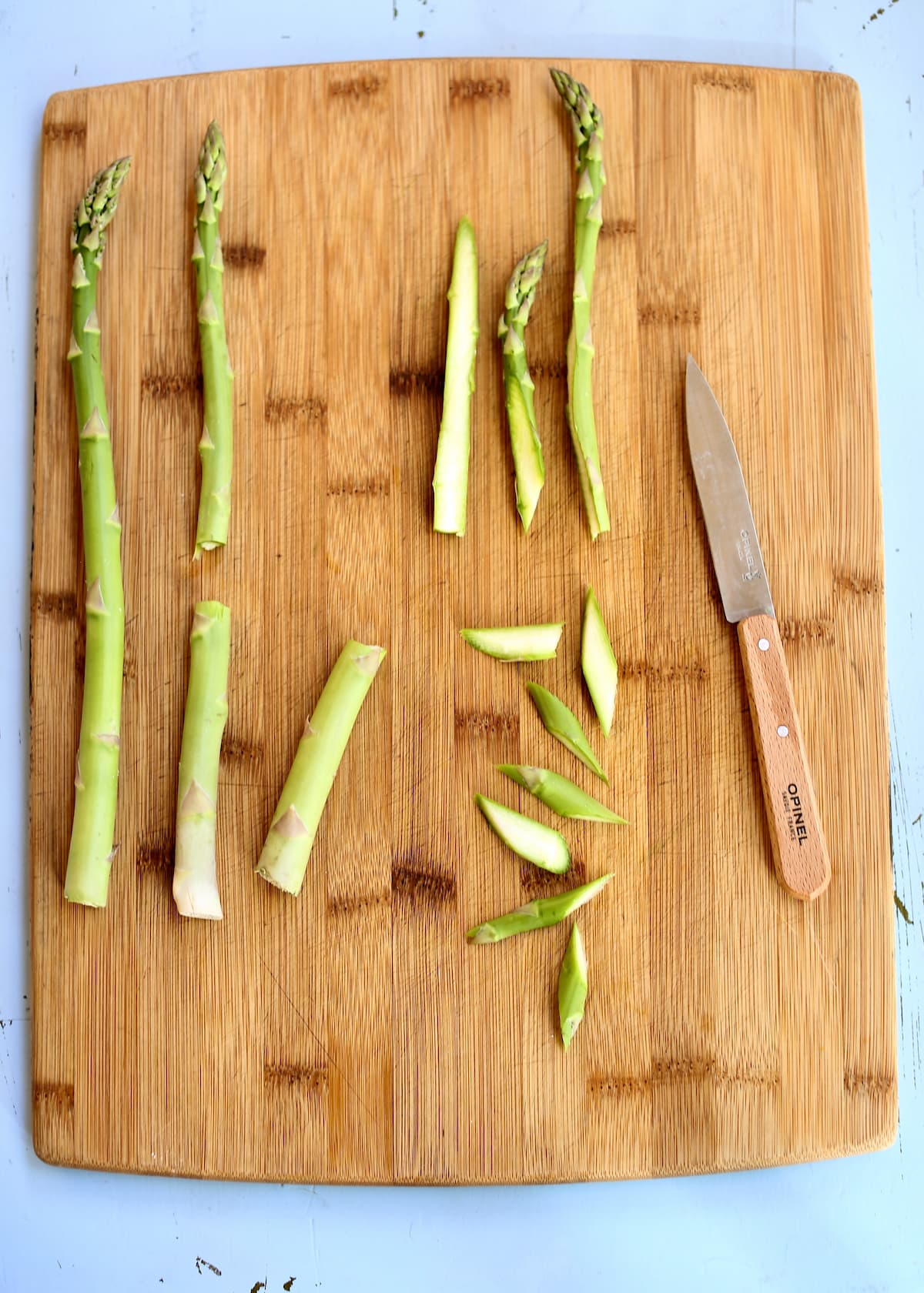 a cutting board with asparagus cuts on it.