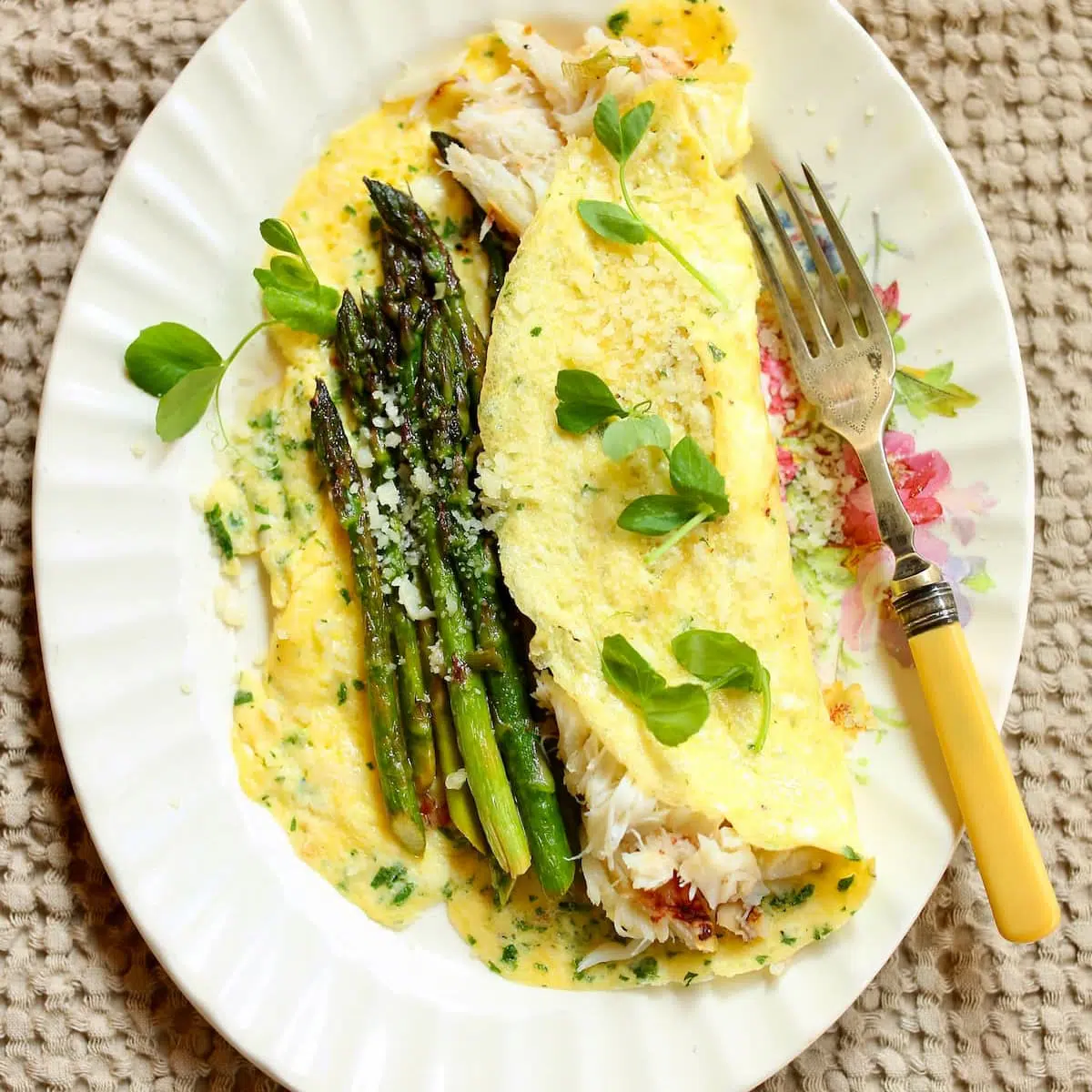 an omelette on a plate with fork.