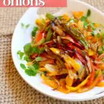 a side photo of a platter of grilled peppers and onions.