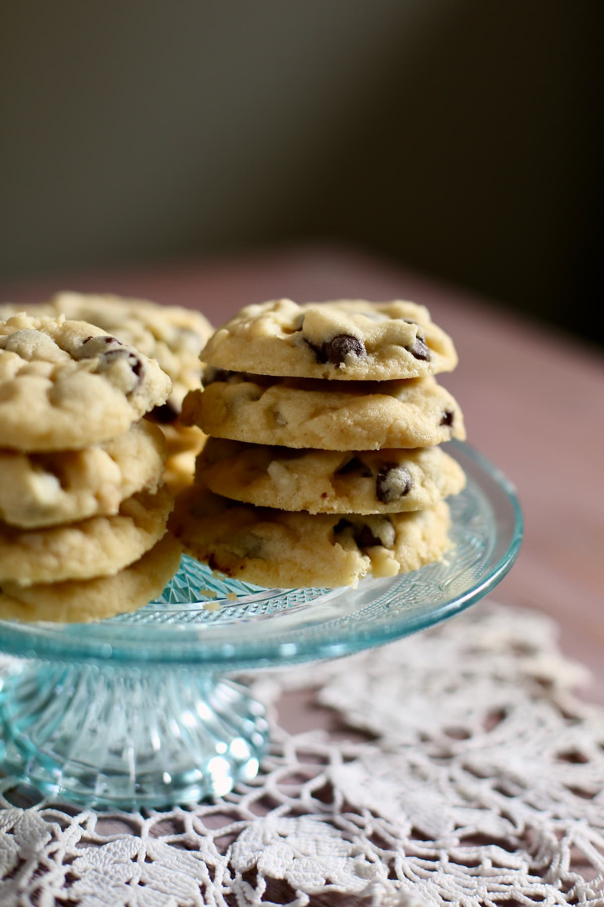 a bue glass tray with stacks of cookies on them.