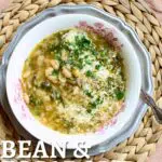 a bowl of bean soup on a table with a spoon.