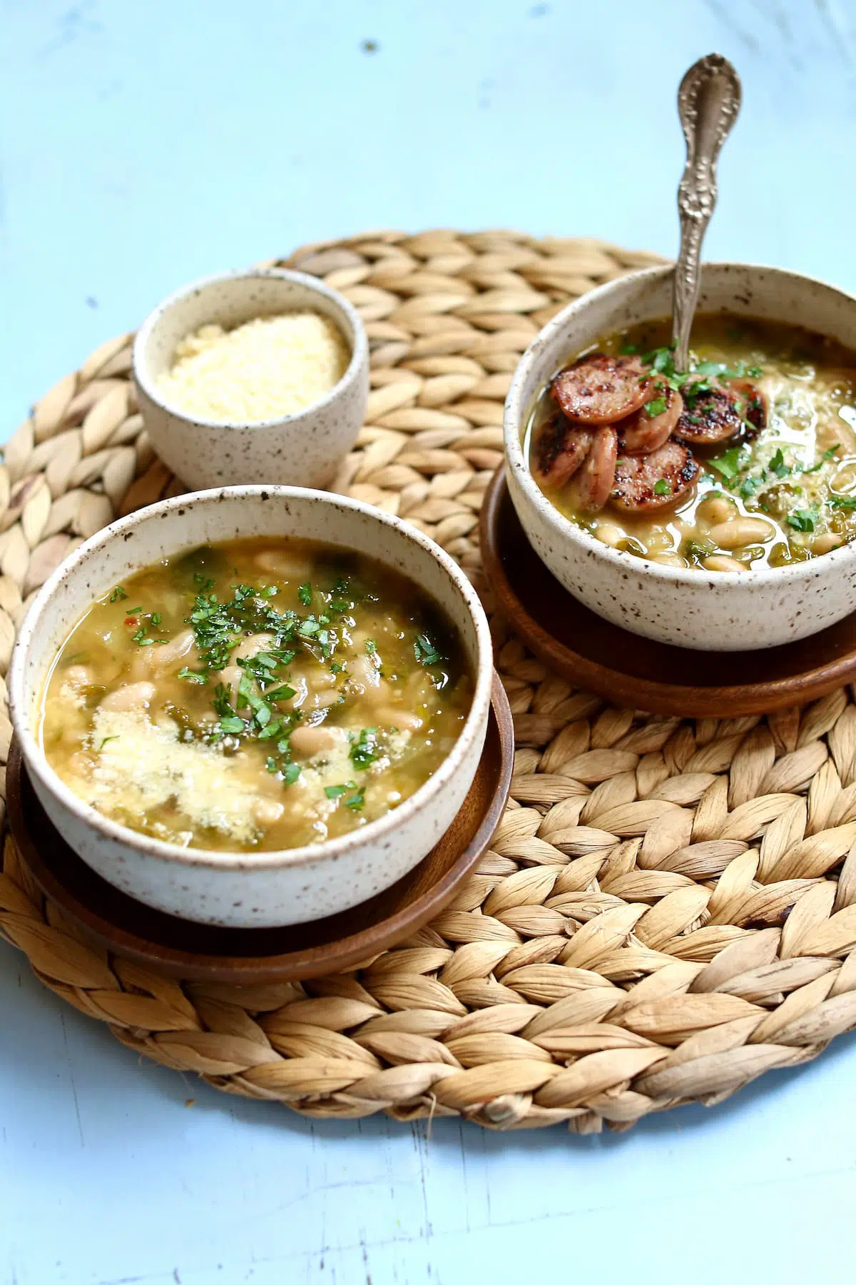 two bowls of soup, one with sausage.