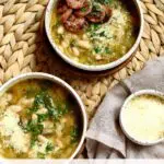 two bowls of soup on a table.