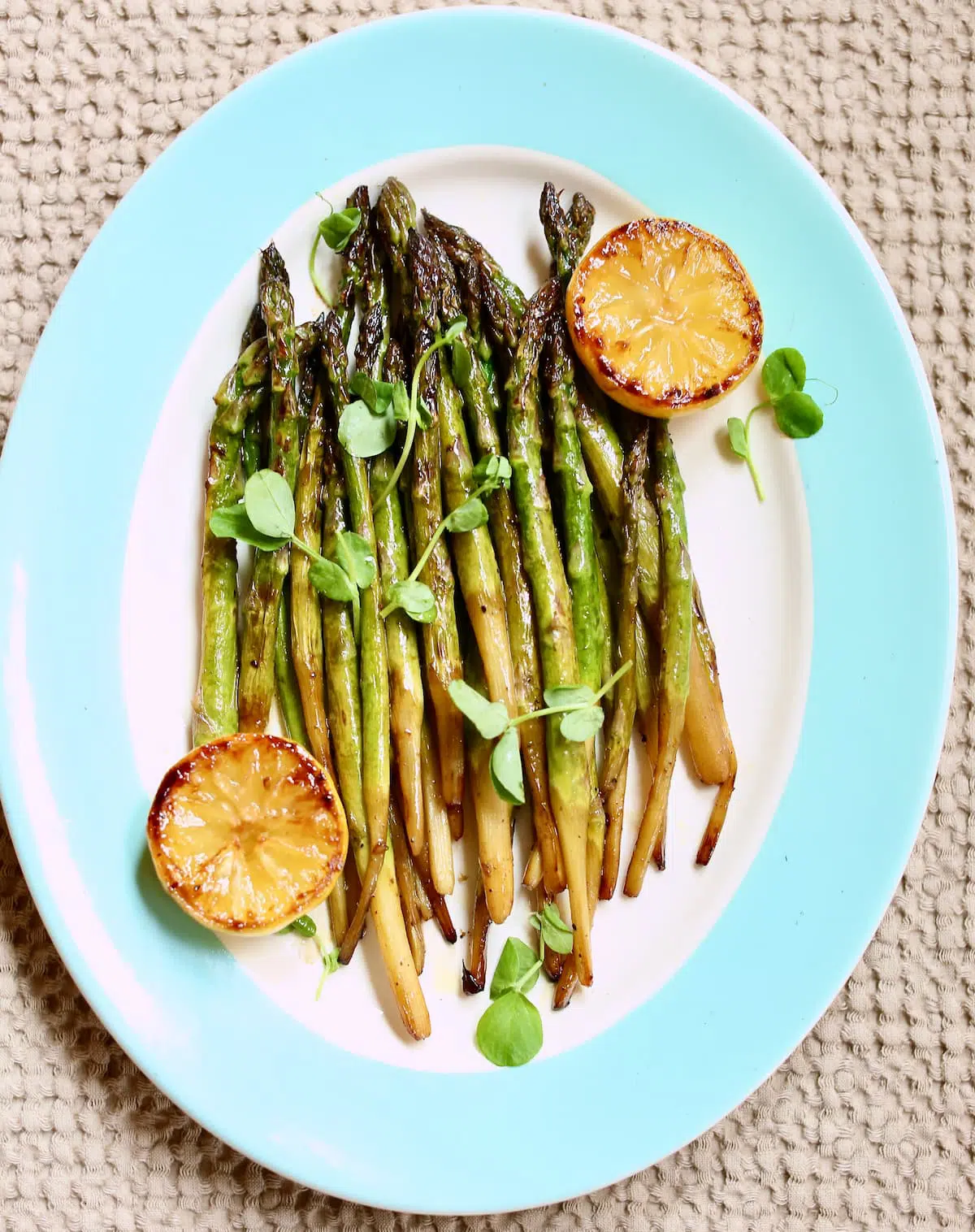 a platter of asparagus and lemon. 