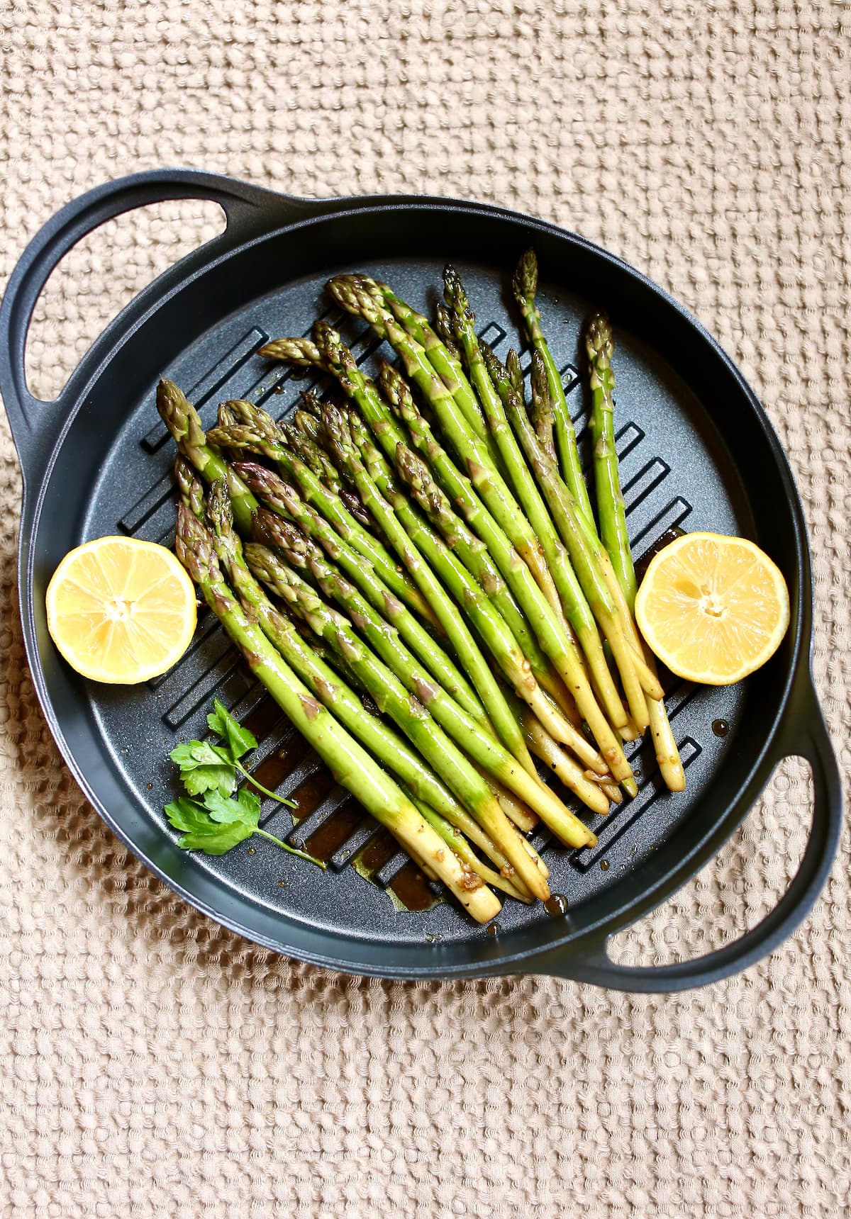 a grill pan with asparagus in it.