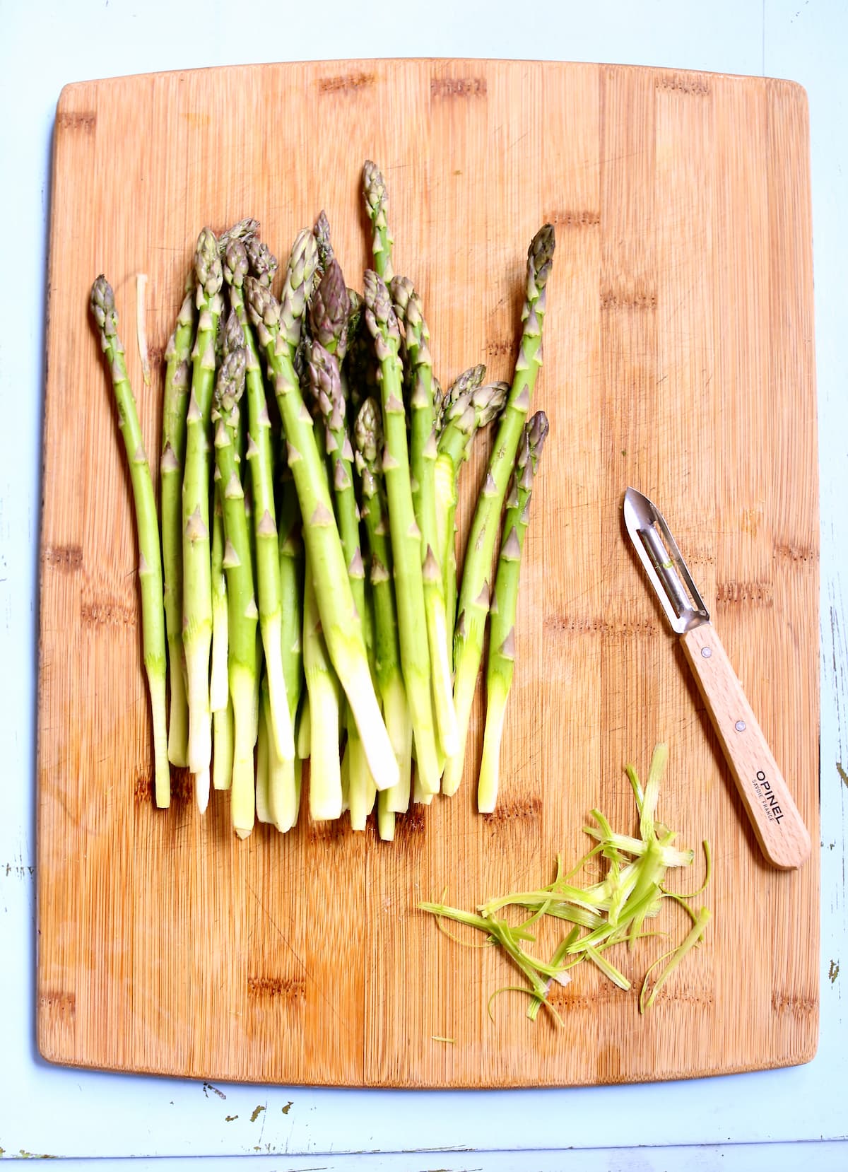 a cutting board with asparagus on it.
