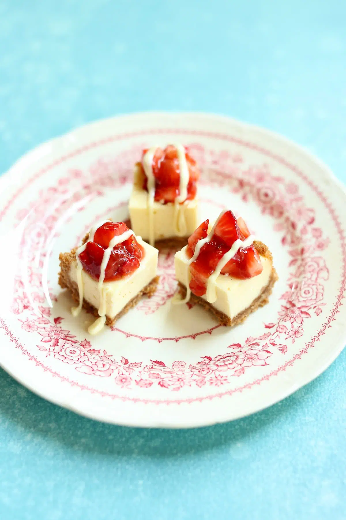 a plate with cheesecake bars on it.