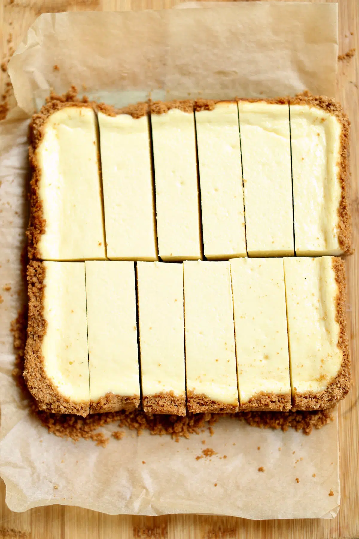 a square cheeecake cut into 12 long pieces.