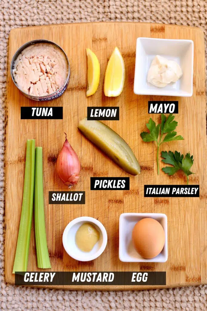 a board with the ingredients for a tuna salad, each of them labeled.