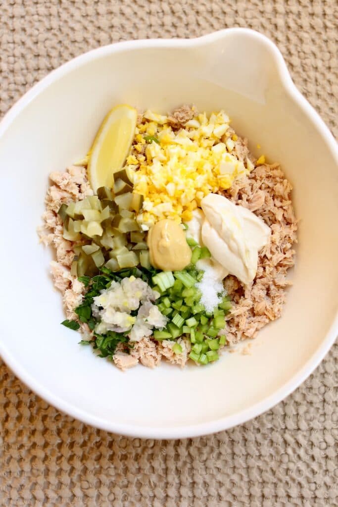a bowl of ingredients for tuna salad.