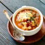 a bowl of pasta and bean soup with a text overlay saying the recipe name.