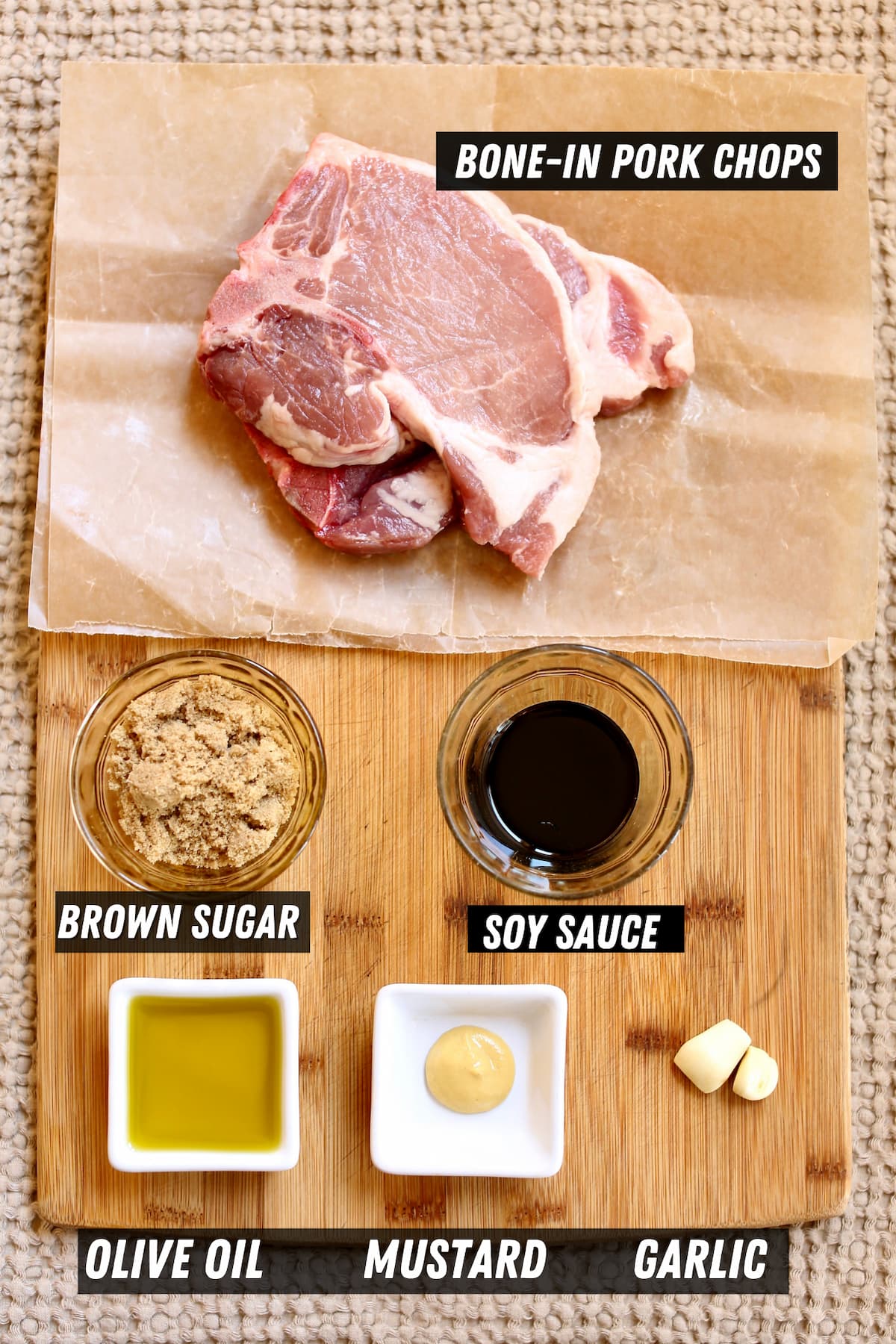 a cutting board with ingredients on it to marinate pork chops.