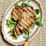 a photo of a pork chop with color block and text that says the recipe name.