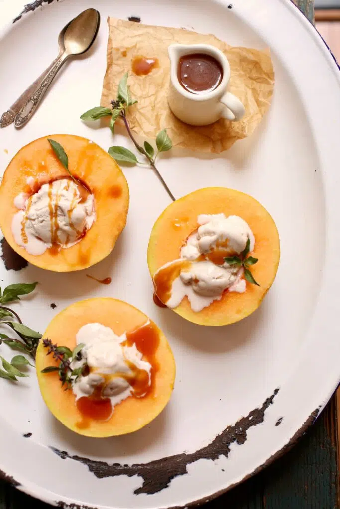 a white tray with cantaloupe and ice cream on it.