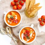 bowls of tomato soup and crackers on a white platter with text overlay saying the recipe name.