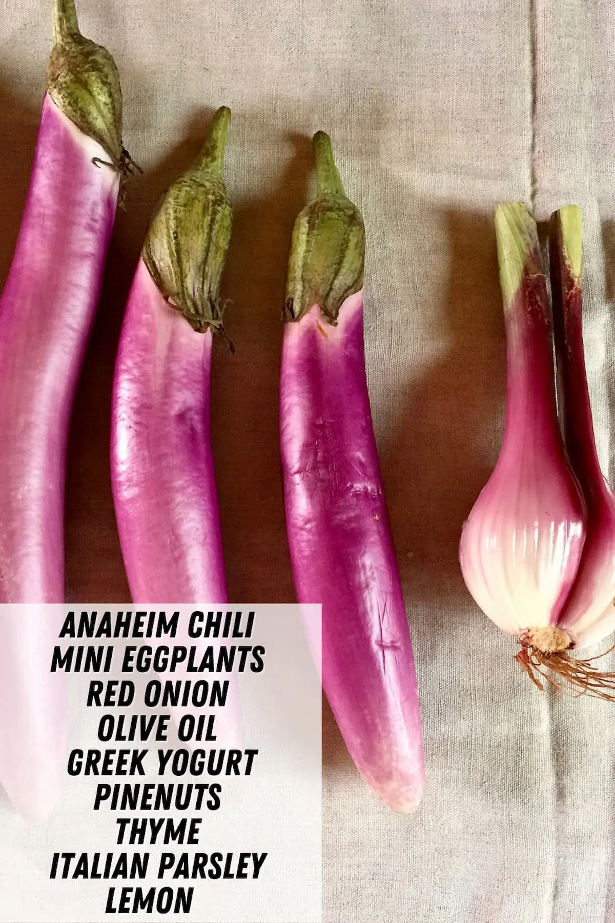 a table of eggplants, with text overlay saying the ingredient names.